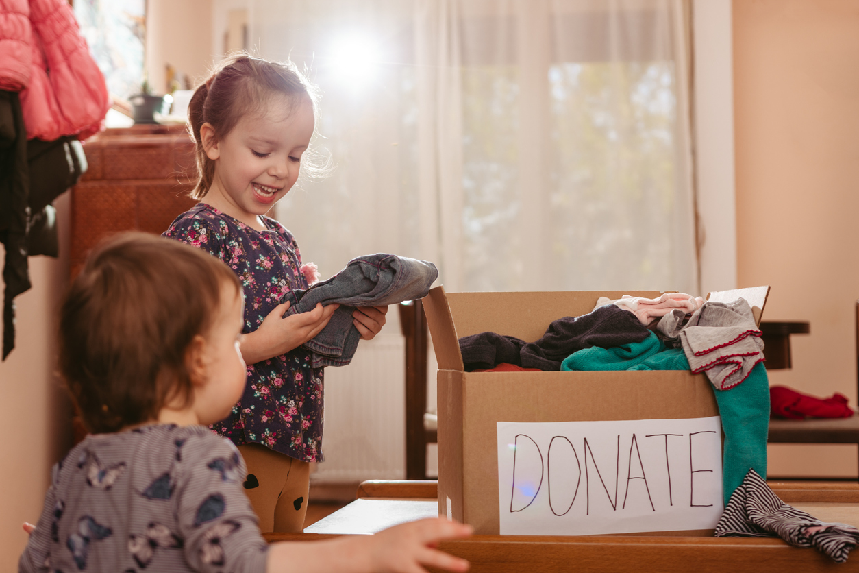 Child sorting clothes for donation