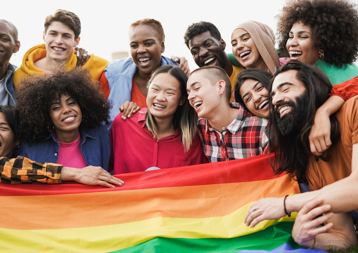 Group of happy diverse people having fun outdoor with LGBT rianbow flag - Focus on bald girl Group of happy diverse people having fun outdoor with LGBT rianbow flag - Focus on bald girl