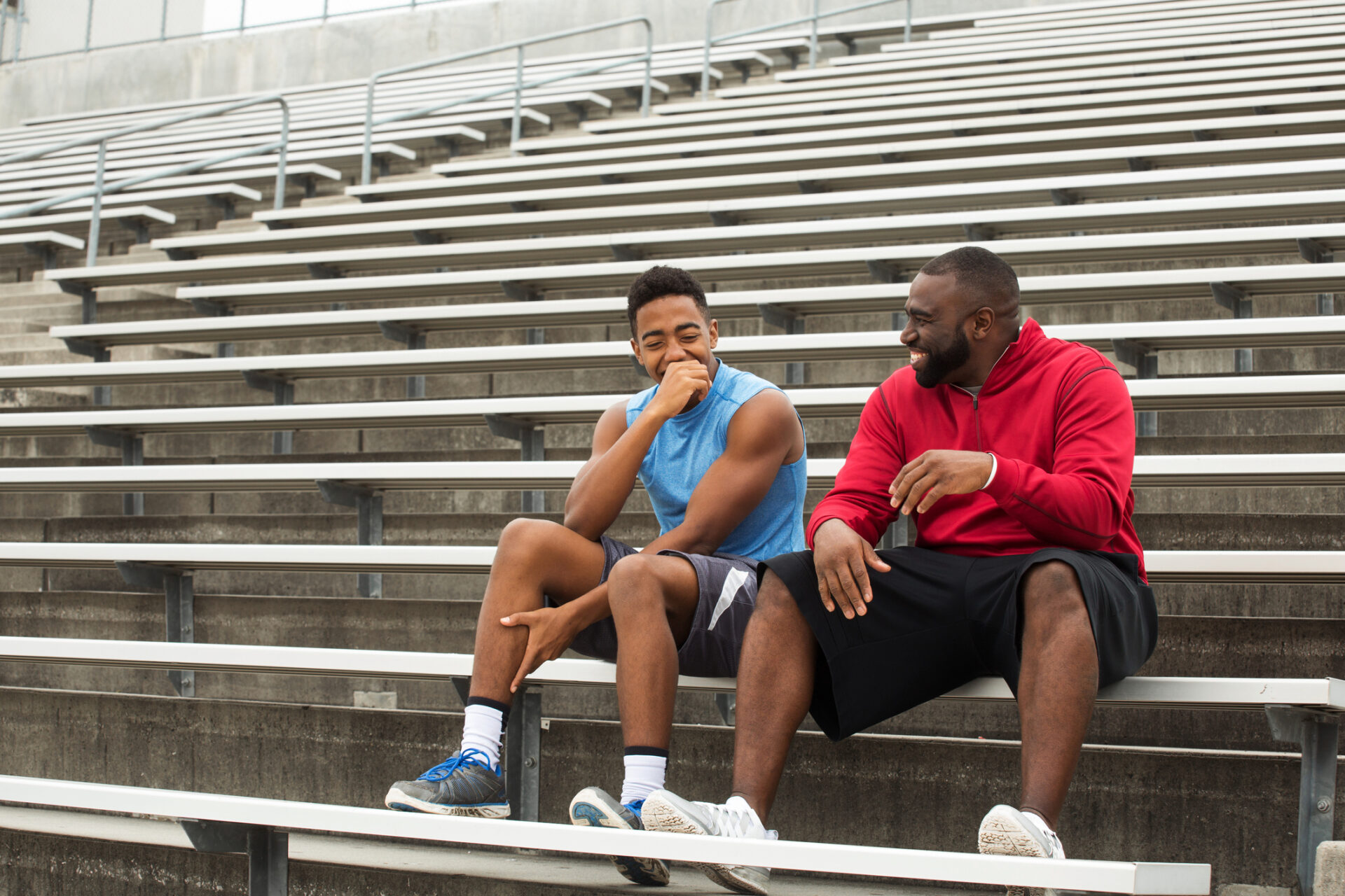 Mentor and role model spending time with the youth. Mentor and role model laughing and spending with the youth.
