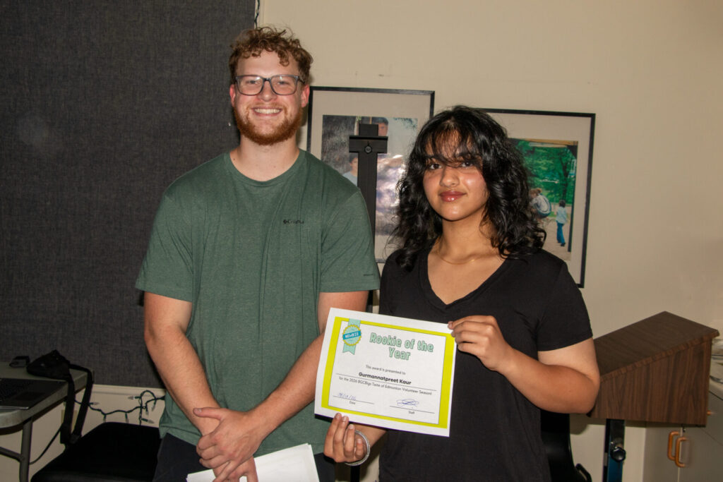 BGCBigs youth volunteer celebrating with their recognition awards at Taste of Edmonton 2026.